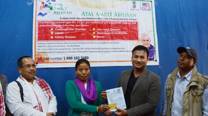 Debolala Gorlosa CEM,NCHAC hand over an Atal amrit card to a benificiary at Haflong on Wednesday in presence of EM Kulendra Daolagupu .