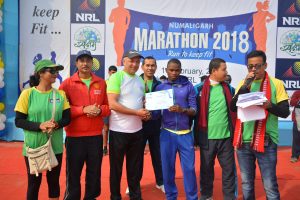 The winner of 21.1 km Numaligarh Marathon, James Ndii Nyawari of Kenya, receiving prize from MD NRL.