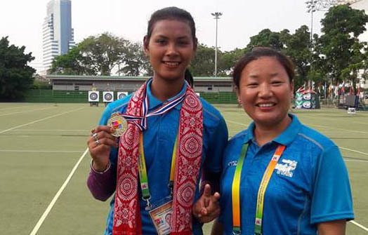 Promila Daimary with her first time individual gold medal posing with her coach.