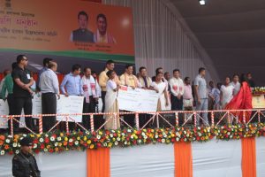 Chief Minister Sarbananda Sonowal distributing cheques to beneficiaries under Kanaklata Mahila Sabalikaran Achoni at a programme at Dhakuakhana in Lakhimpur district.