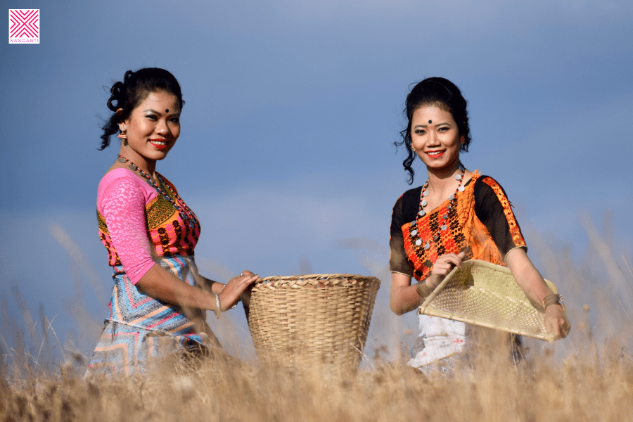 Season’s song Tribal women singing and dancing while harvesting paddy